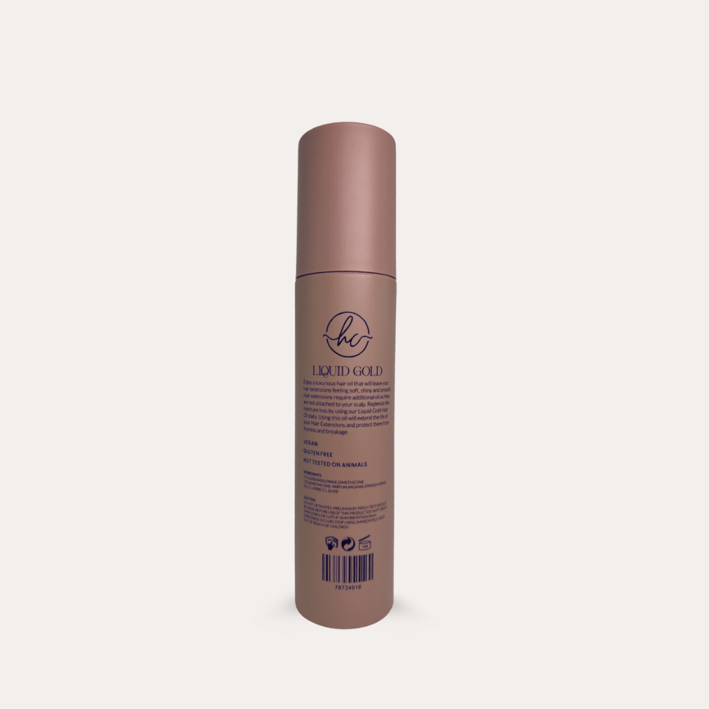 Hair product bottle labeled 'Liquid Gold' on a light beige background