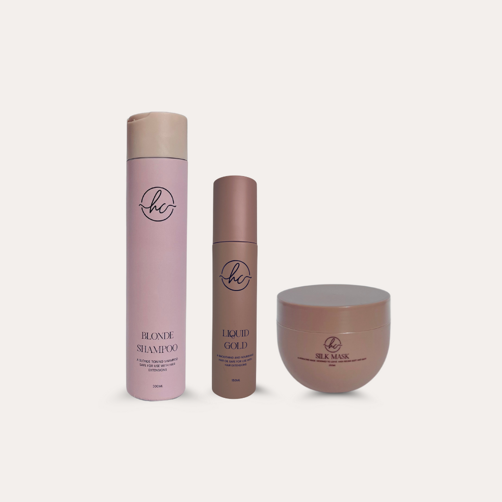 A set of hair care products including a shampoo bottle, a hair oil bottle, and a hair mask jar, all with a pink and beige color scheme and labeled 'Hair Candy'.