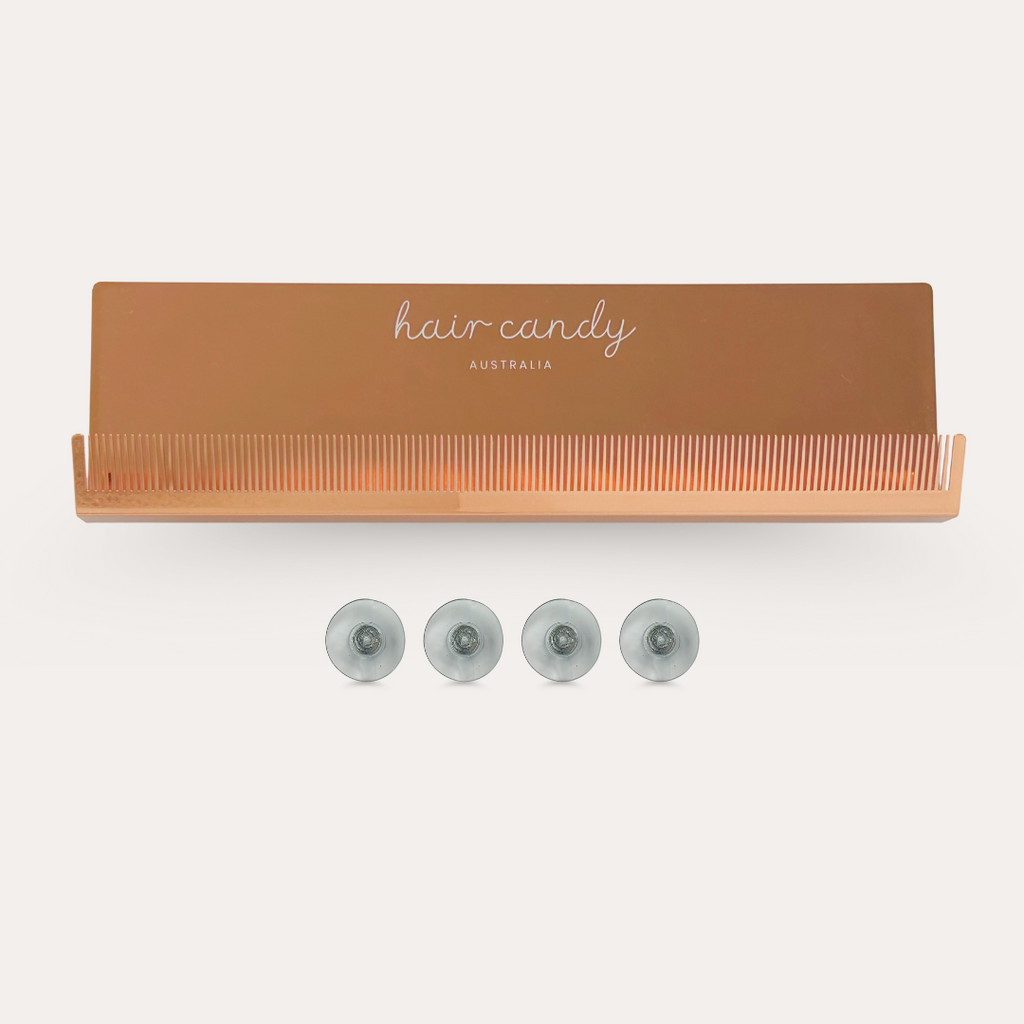 A rose gold extension holder with suction cups, branded 'hair candy Australia', designed to organize hair extensions.