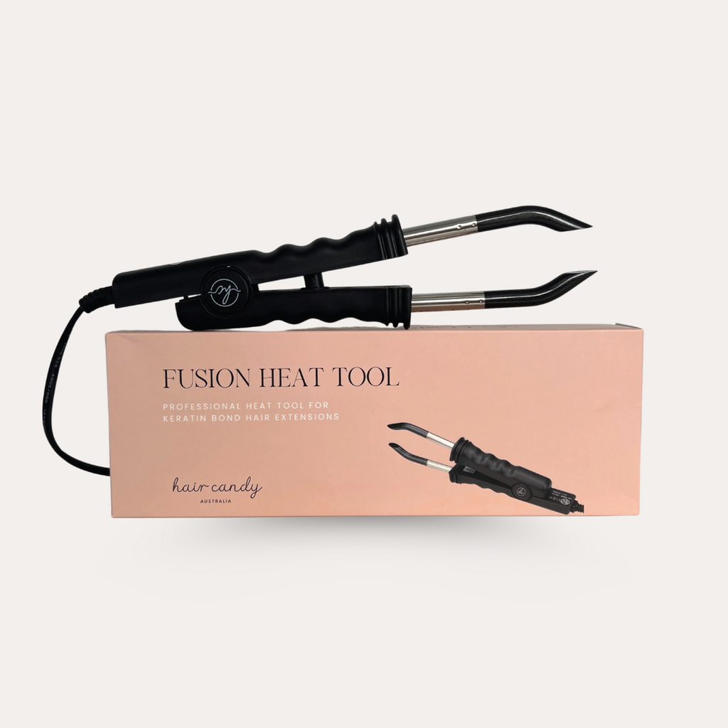 A Fusion Heat Connector Machine for hair extensions, displayed alongside its packaging box which has 'FUSION HEAT TOOL' written on it.
