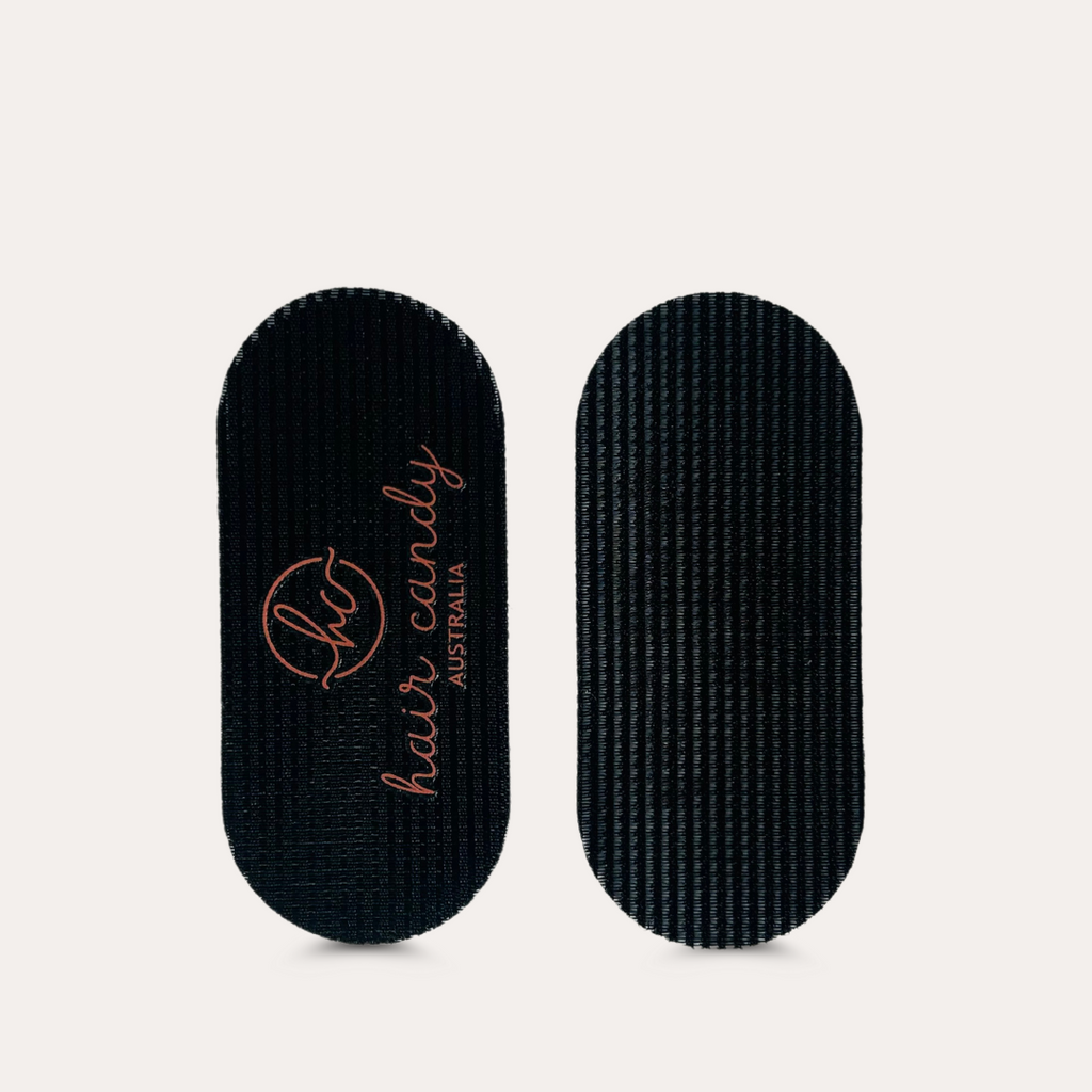 Two black velcro hair grips with the 'Hair Candy' brand logo visible on the top grip.