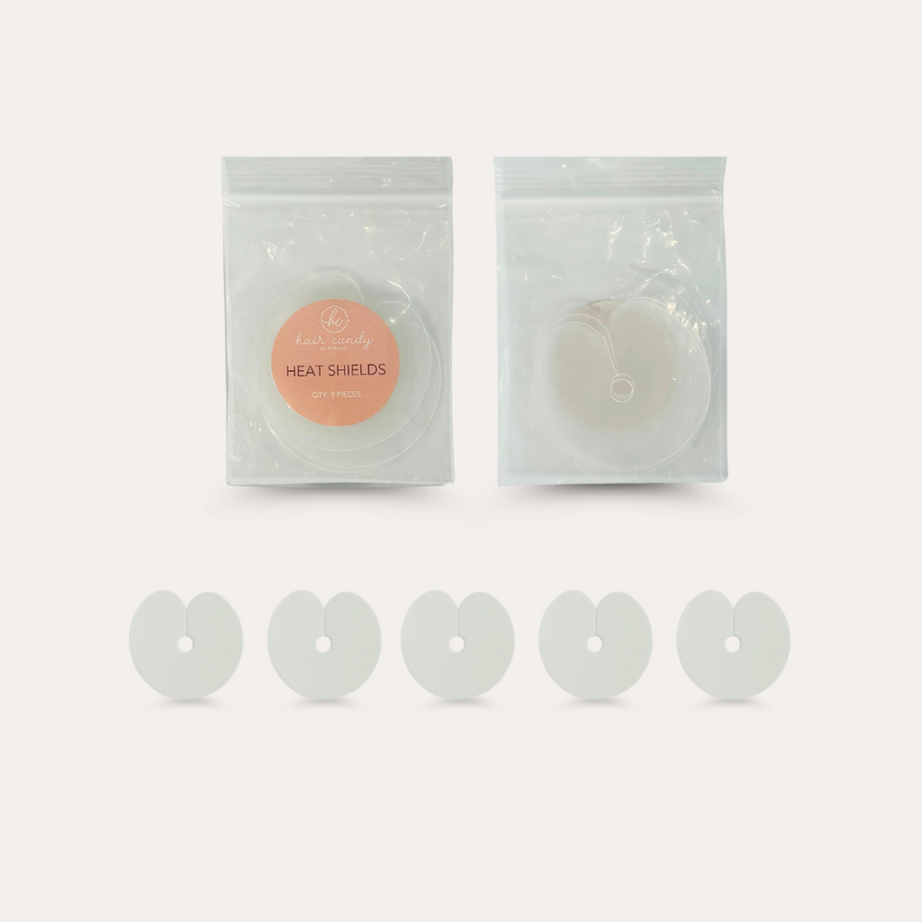 Packaging and multiple heat shields displayed in a single row outside the packaging.