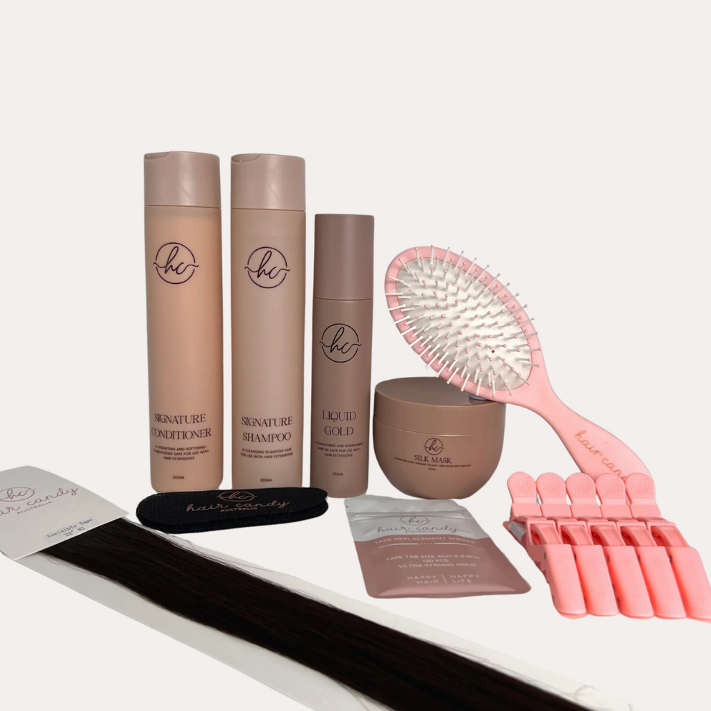 An assortment of hair extension tools and products including invisible tapes, hair grips, alligator clips, a wet brush, and other retail products.
