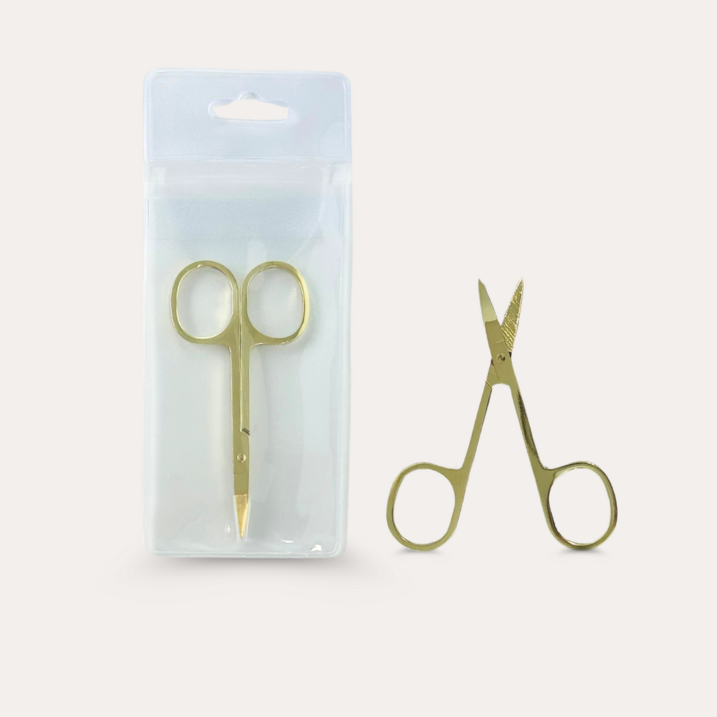 Mini stainless steel scissors with a gold-colored finish, packaged in a clear plastic blister pack. The scissors have pointed tips