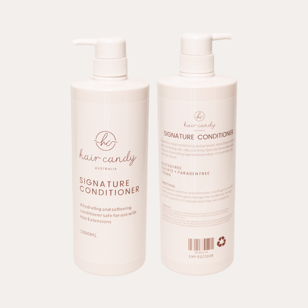Two bottles of 'The Hair Candy' Signature Conditioner on a white background