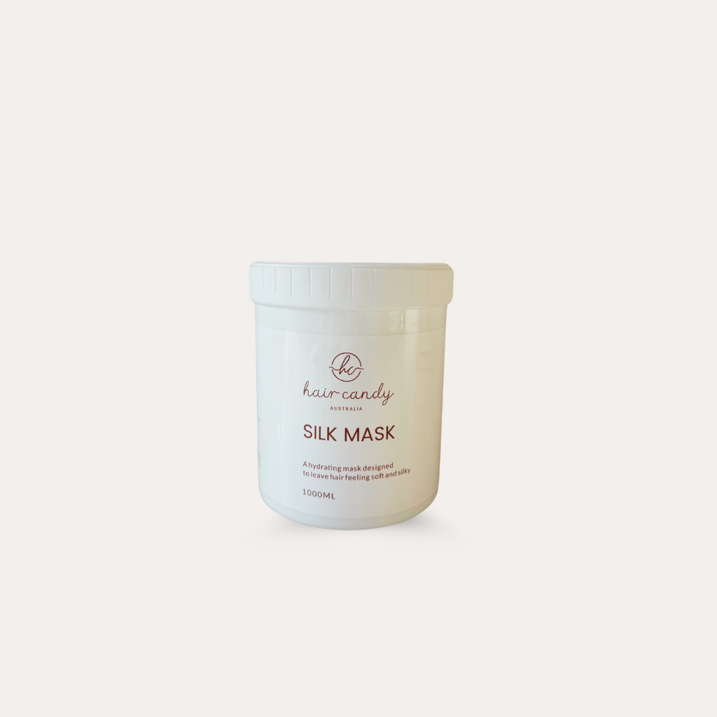 A white container labeled 'Hair Candy Silk Mask' designed for hair extensions treatment.